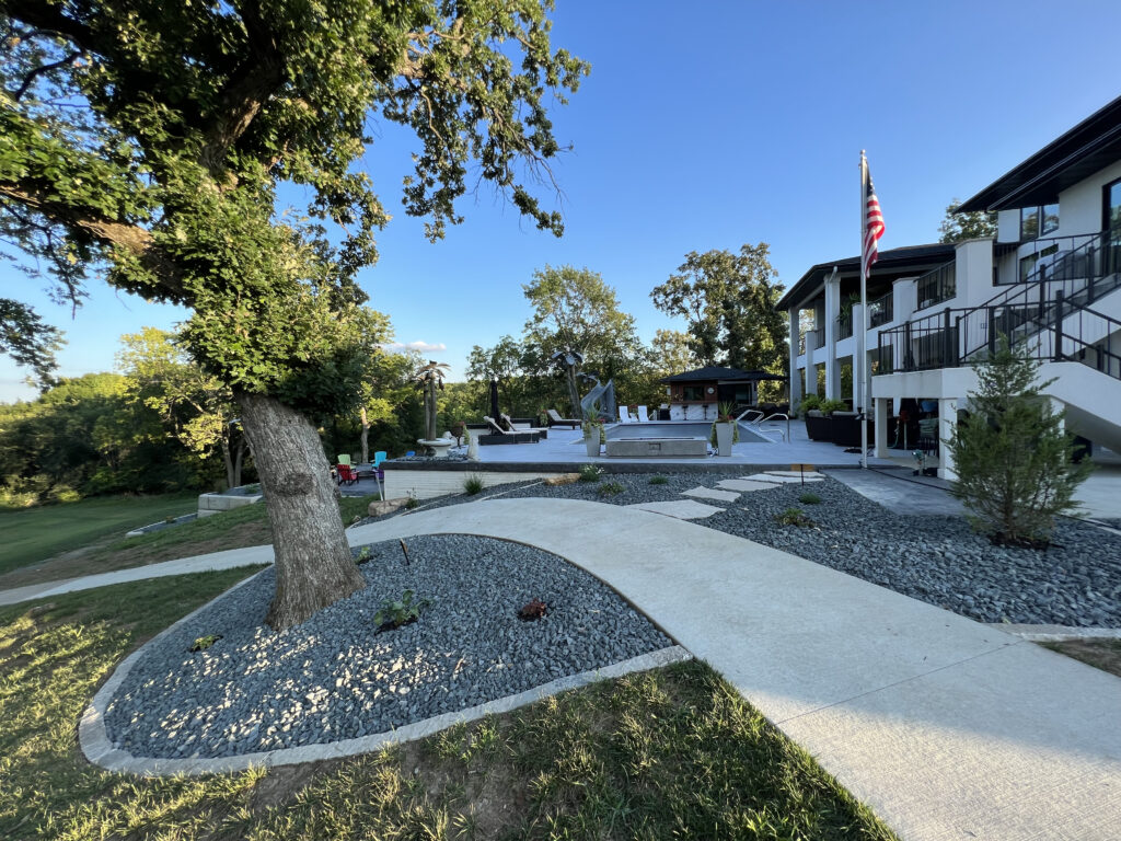 concrete-walkway-around-pool-back-of-house