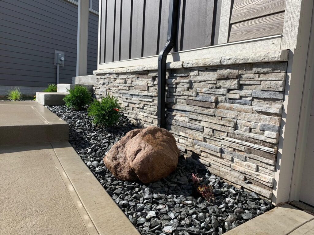 stone-flower-bed-inside-concrete-sidewalk