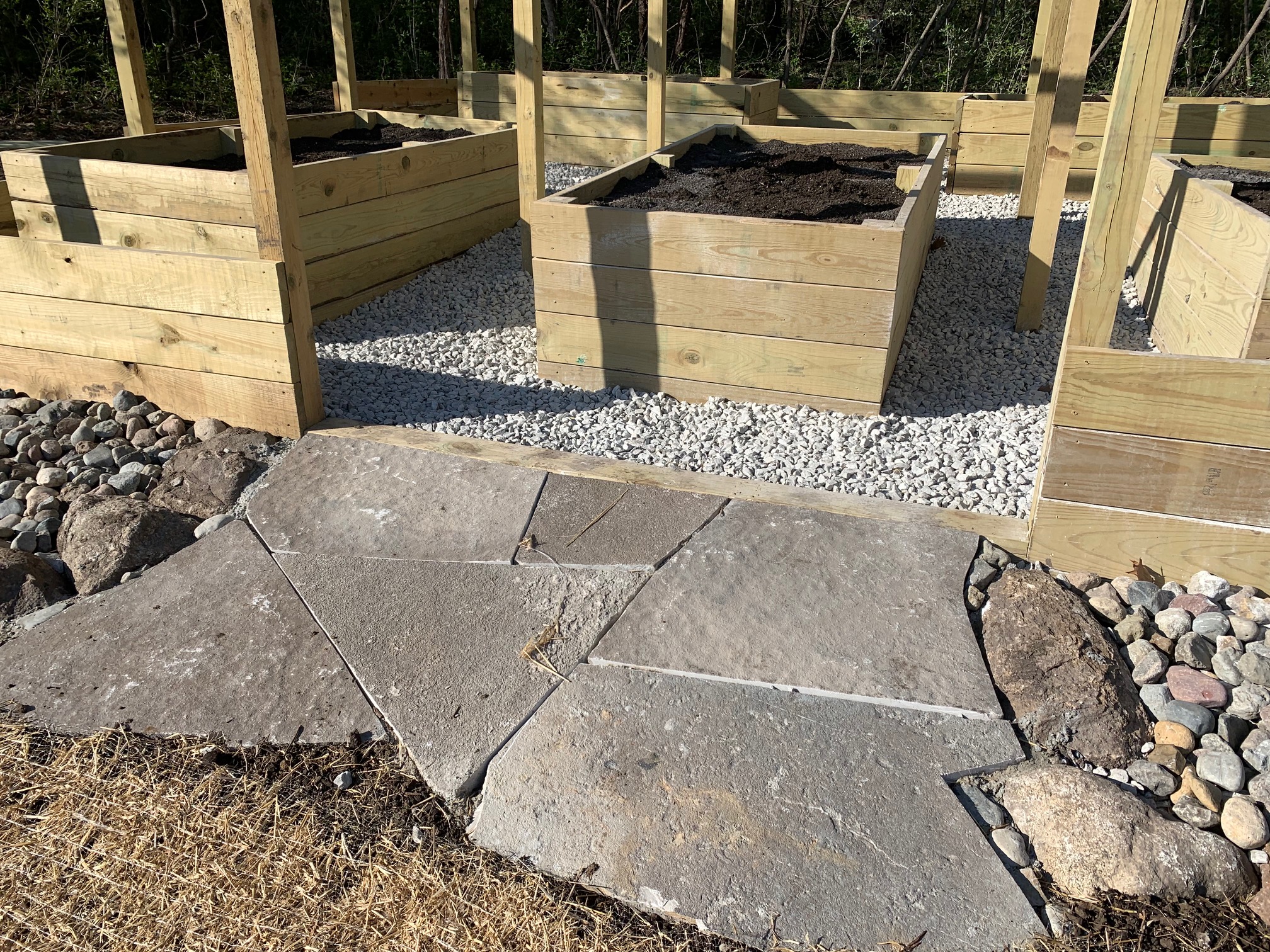 stone-path-leading-up-to-raised-garden-beds